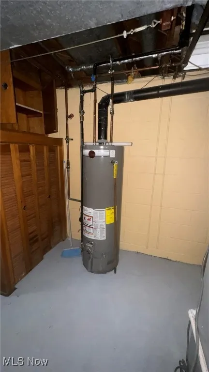 Utility room featuring gas water heater