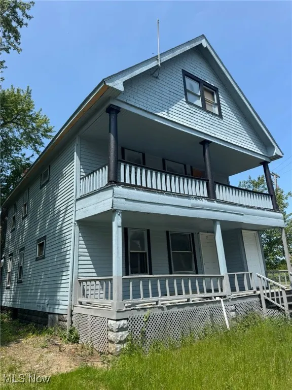 View of front facade featuring a balcony and a porch