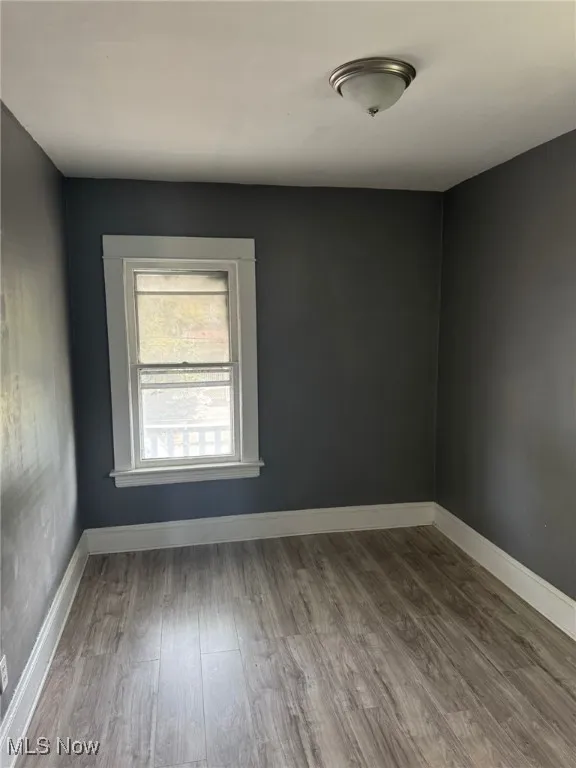 Empty room with wood finished floors and baseboards