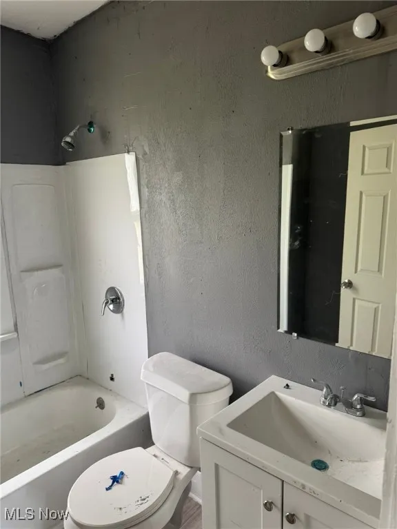 Full bathroom featuring vanity, toilet, and bathtub / shower combination