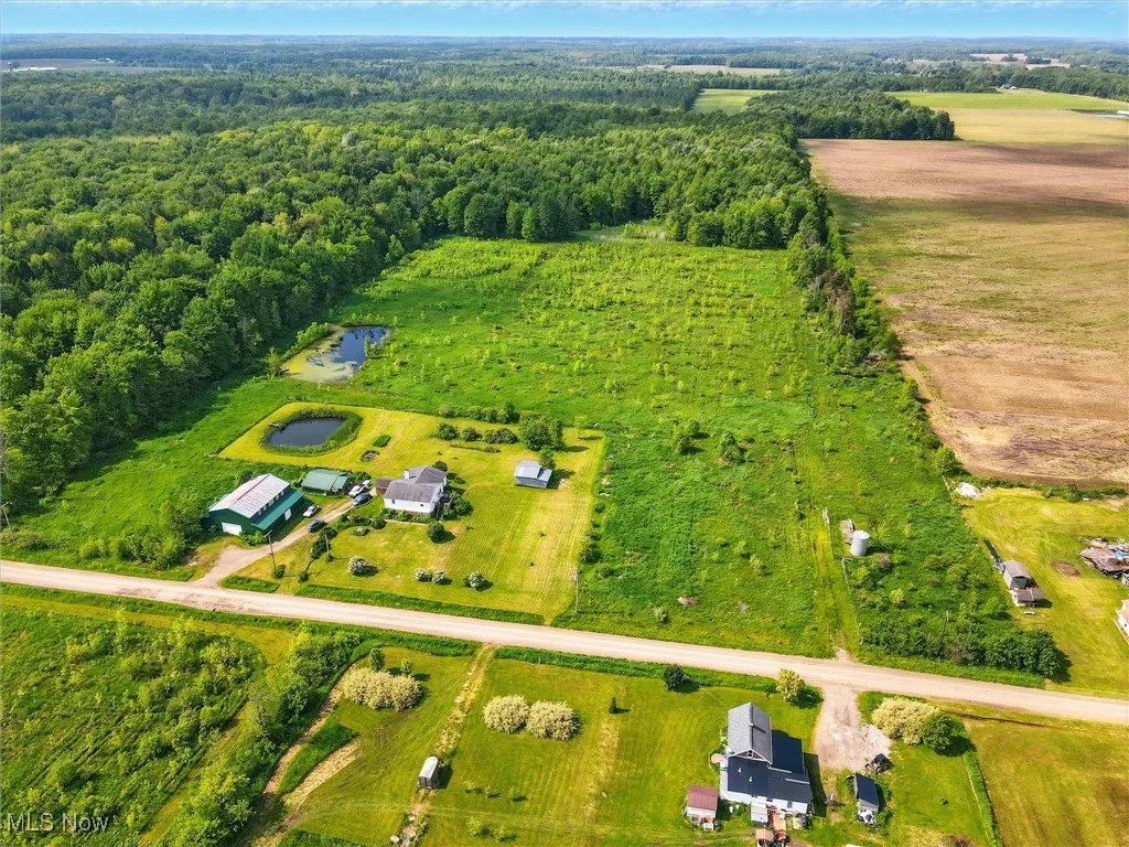 Overview of rural landscape featuring a heavily wooded area