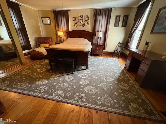Bedroom with wood finished floors