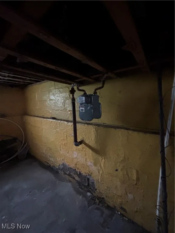 Unfinished below grade area featuring gas meter
