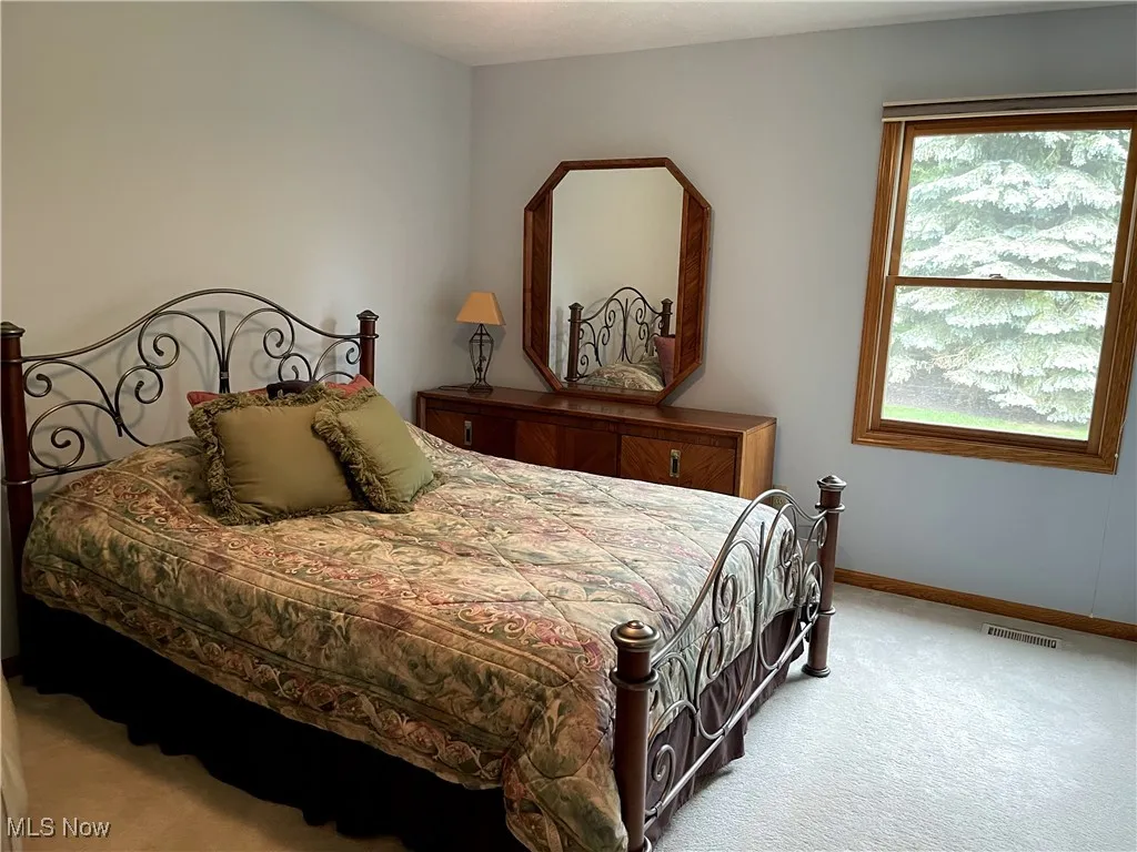 Carpeted bedroom featuring baseboards