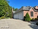 View of side of home with an attached garage and driveway