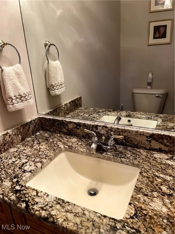 Half bath featuring vanity and toilet