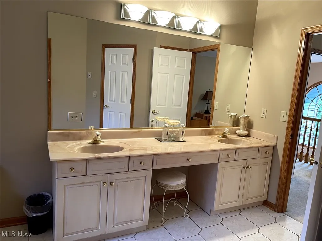 Bathroom featuring double vanity and tile patterned flooring