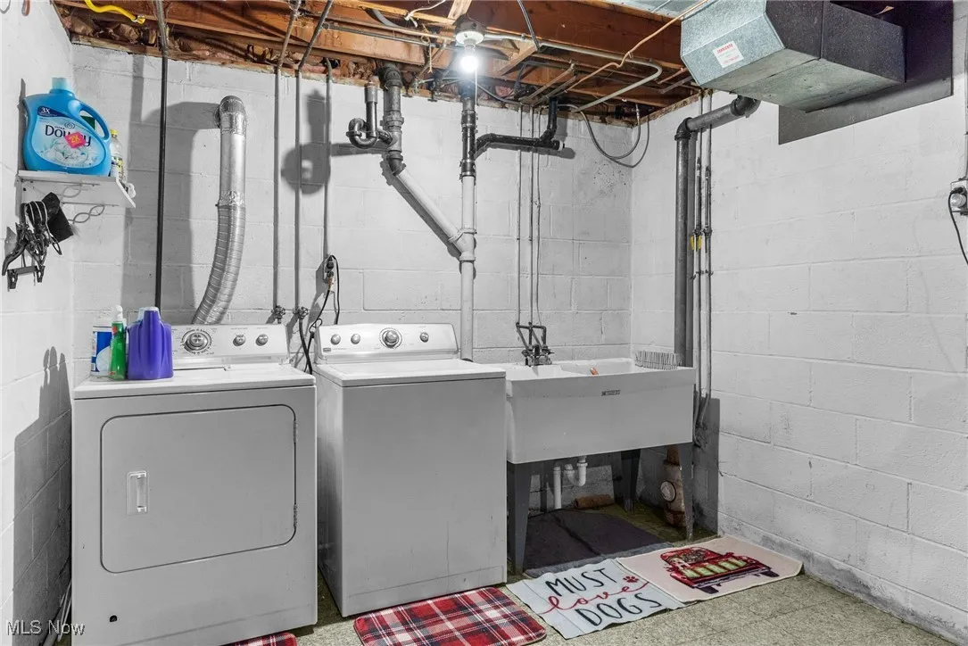Washroom with independent washer and dryer and tile patterned floors