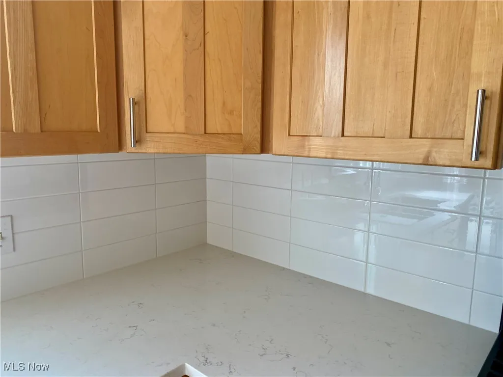 New Quartz countertops and ceramic tile backsplash