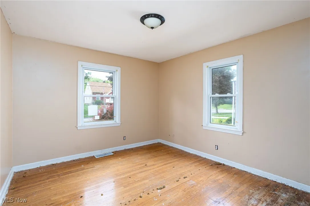 Empty room featuring hardwood / wood-style floors and baseboards