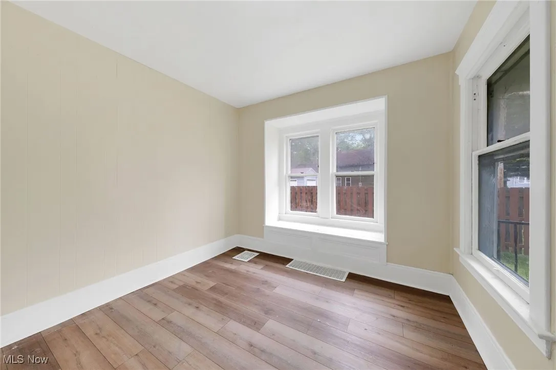 Unfurnished room featuring wood finished floors and baseboards