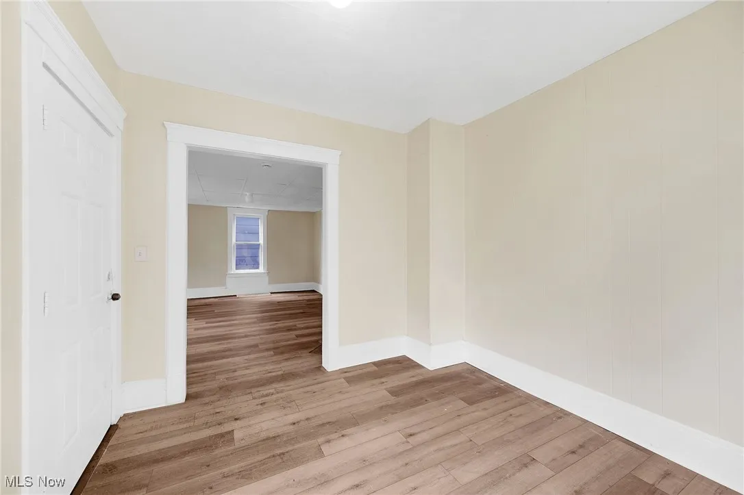 Unfurnished room featuring light wood-type flooring and baseboards