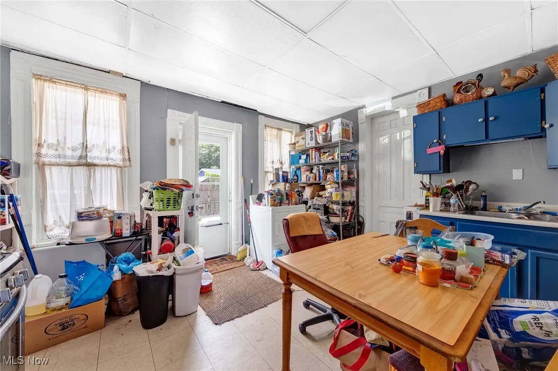 Dining space with a paneled ceiling and light tile patterned floors