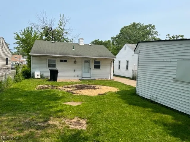 Rear view of property featuring a chimney