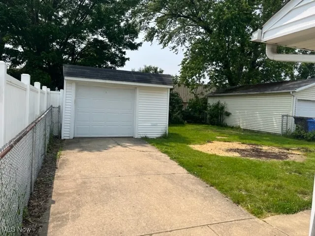 Detached garage featuring driveway