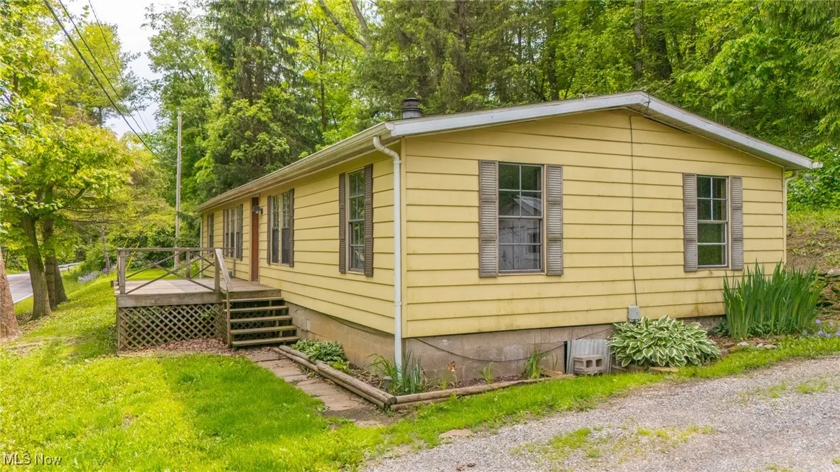 View of home's exterior with a wooden deck