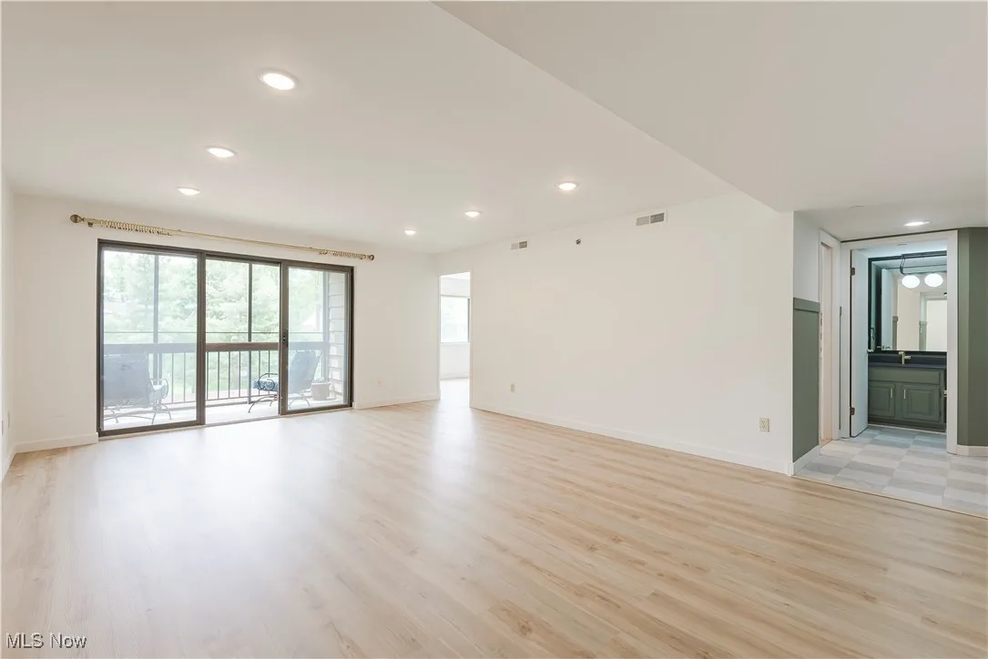 Unfurnished room with recessed lighting, light wood-style flooring, and baseboards