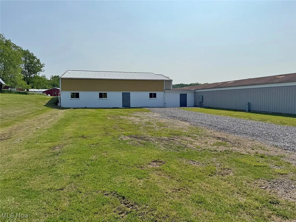View of pole building featuring a lawn and driveway