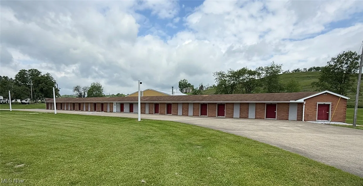 View of front of property with a front lawn and brick siding