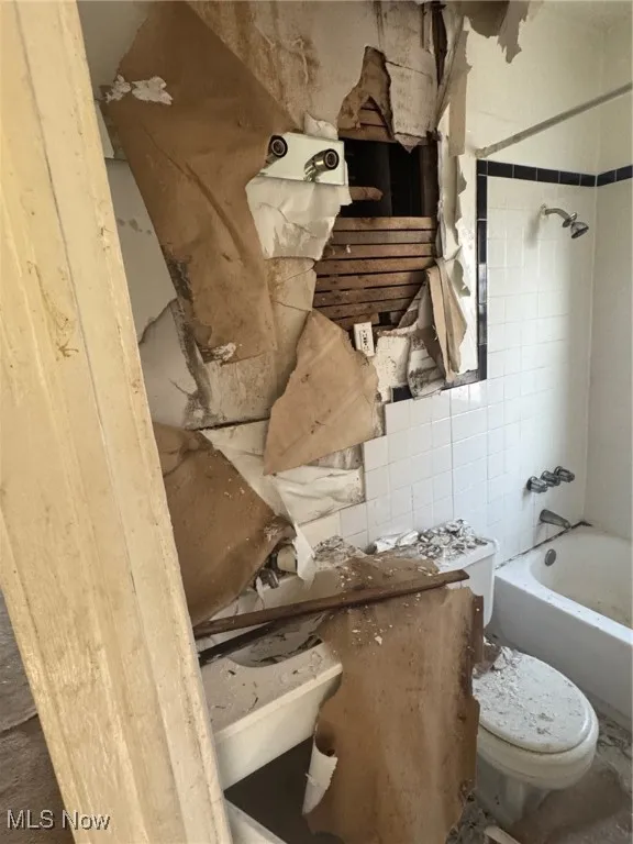 Full bathroom featuring shower / tub combination and toilet