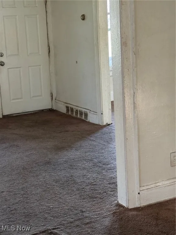 Unfurnished room featuring carpet floors