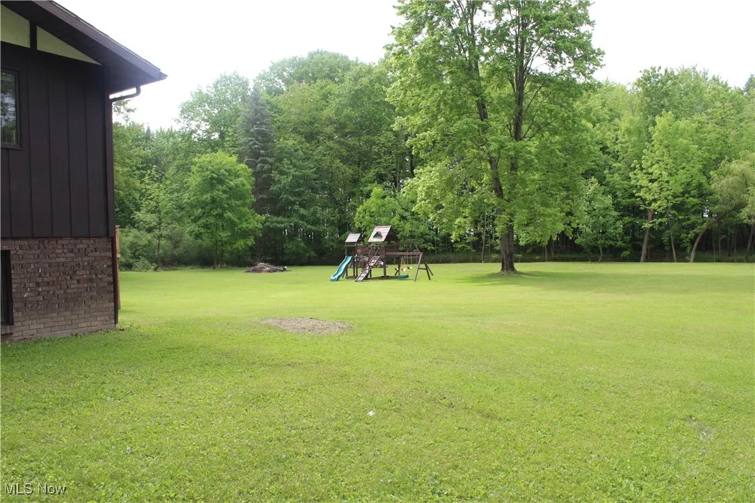 View of grassy yard with a playground