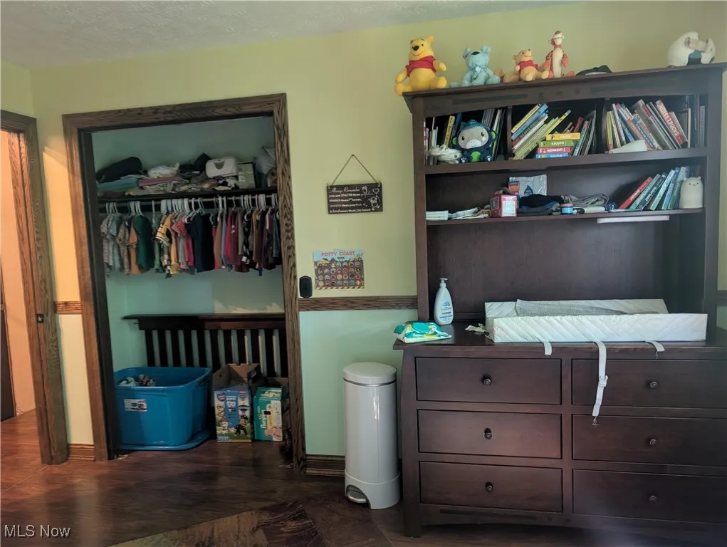 Bedroom with a closet and dark wood finished floors
