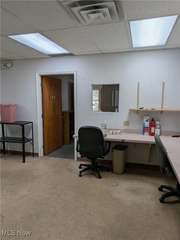Home office featuring a drop ceiling and built in desk