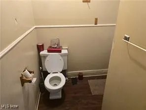 Bathroom with toilet and wood finished floors