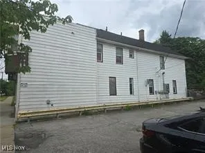 View of property exterior with a chimney