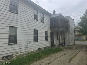 View of side of property featuring a balcony