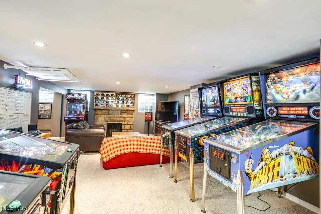 Rec room with carpet flooring, a fireplace, and recessed lighting