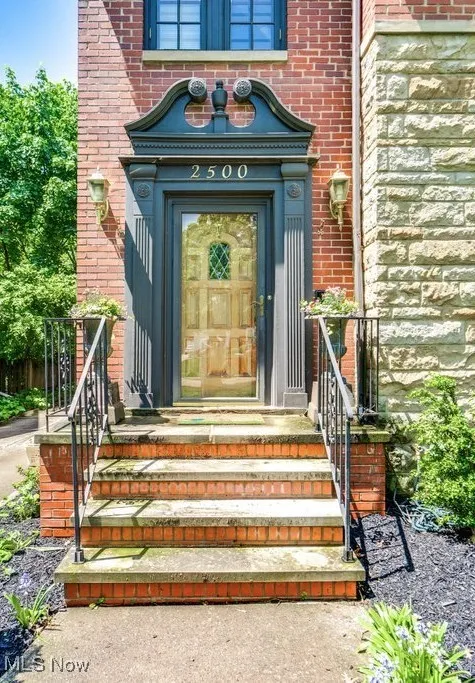 Property entrance featuring brick siding