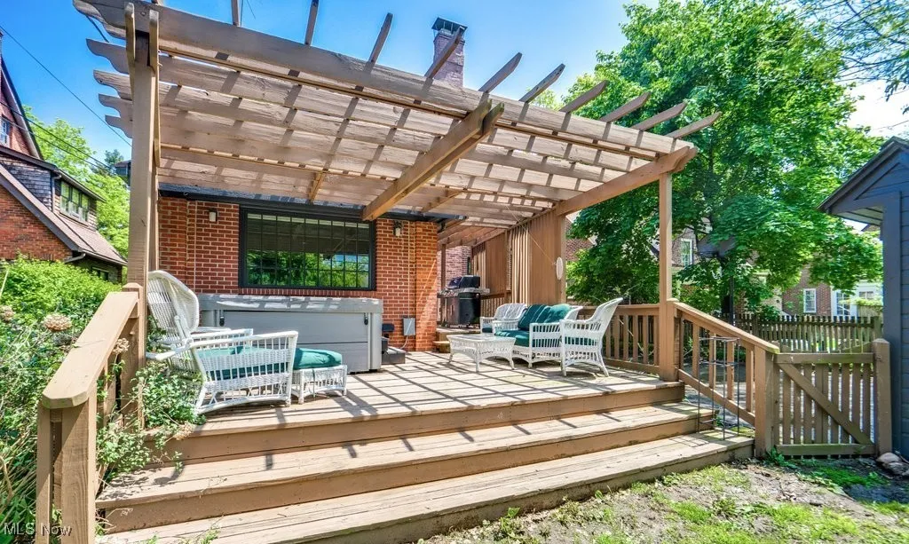 Wooden deck with a fence and a pergola