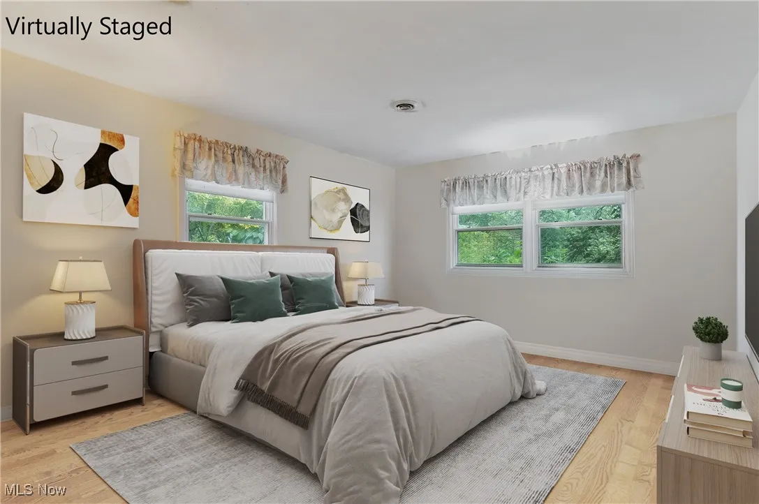 Bedroom featuring light wood-type flooring and baseboards