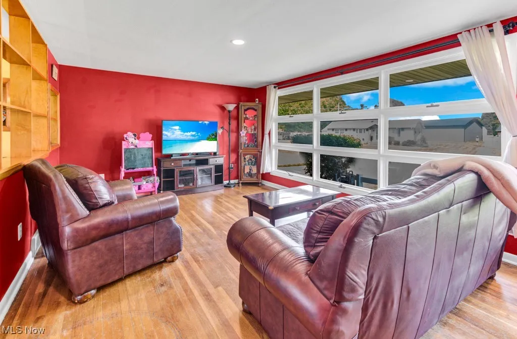 Living area with wood finished floors and recessed lighting