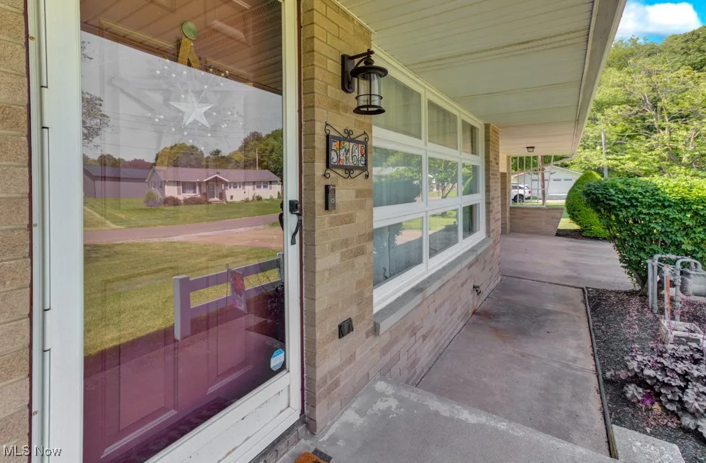 View of exterior entry with a porch
