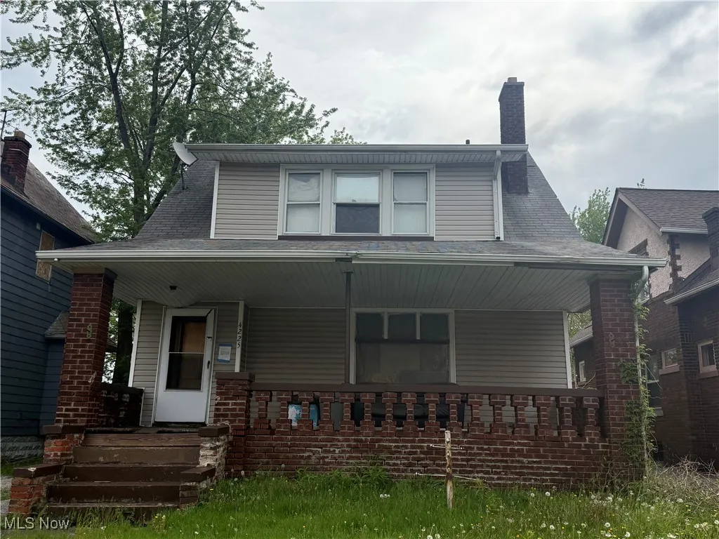 Bungalow with a porch and a chimney