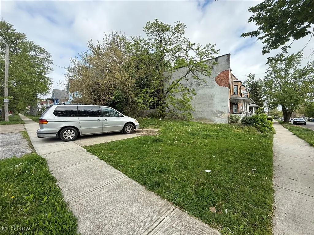 View of side of home featuring a yard