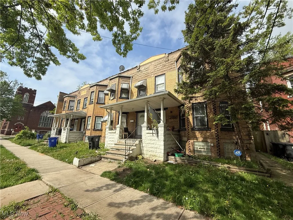 View of property with brick siding