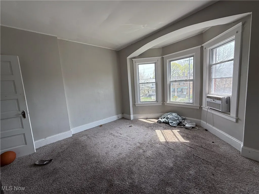 Unfurnished room featuring carpet floors and baseboards