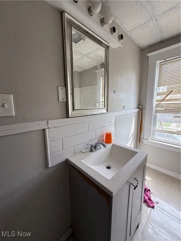 Bathroom featuring vanity and a paneled ceiling