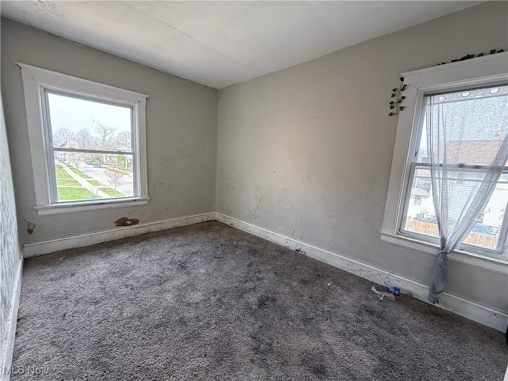 Empty room featuring plenty of natural light and carpet floors