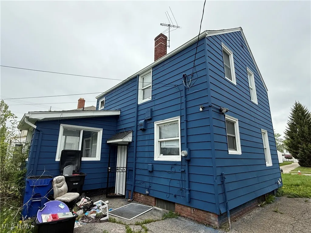 Back of house with a chimney