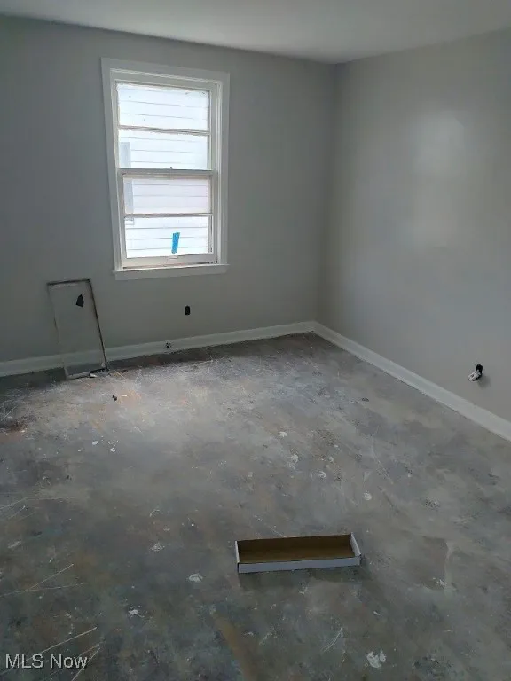 Empty room featuring baseboards
