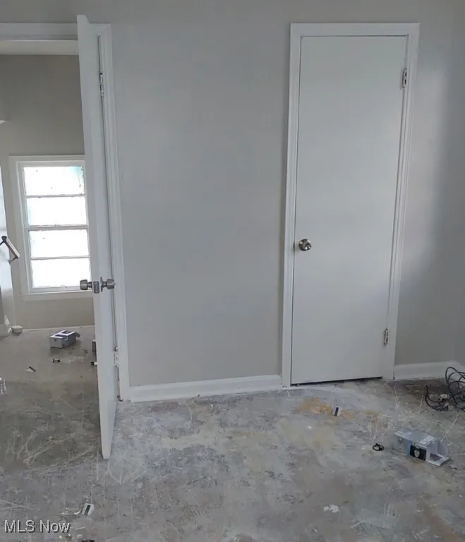 Spare room featuring baseboards