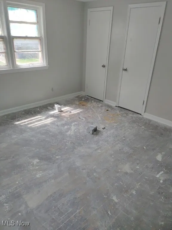 Unfurnished bedroom featuring baseboards