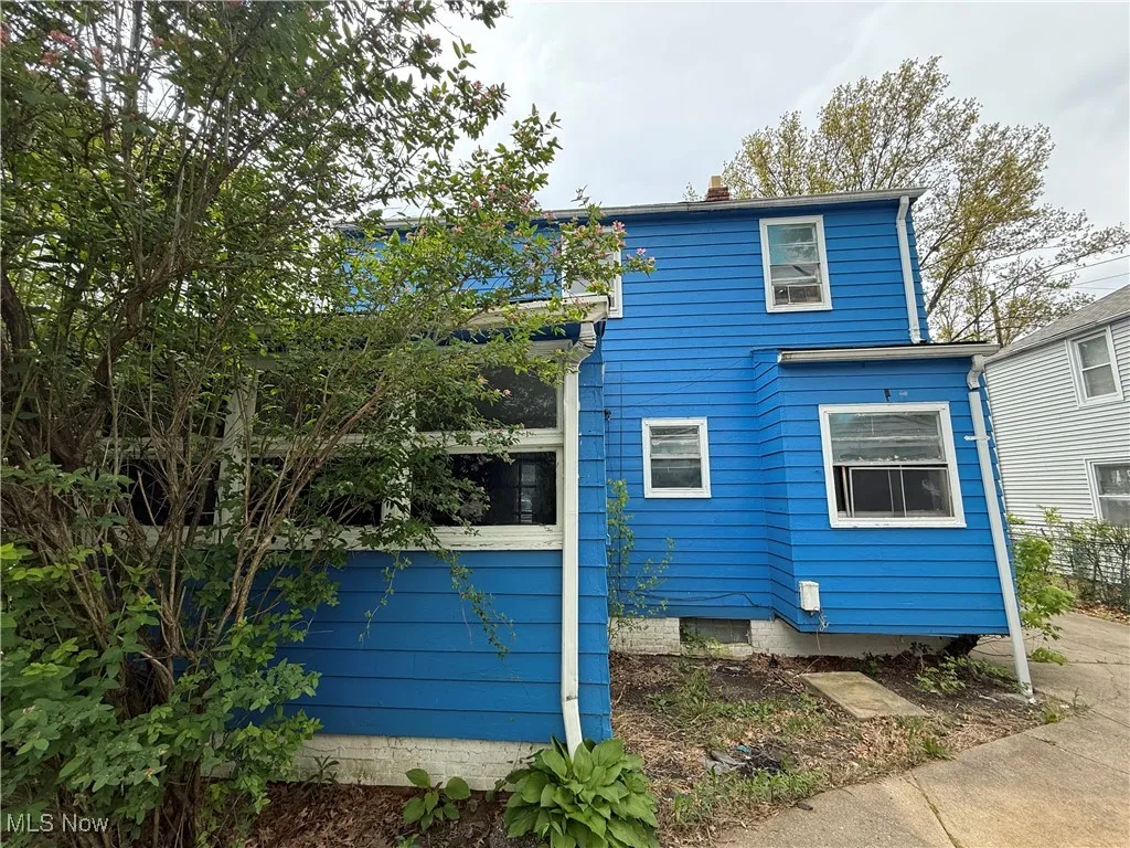View of side of home featuring a chimney