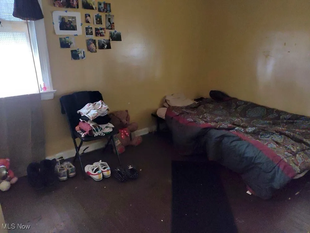 Unfurnished bedroom featuring wood finished floors