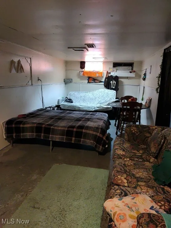 Bedroom featuring concrete flooring